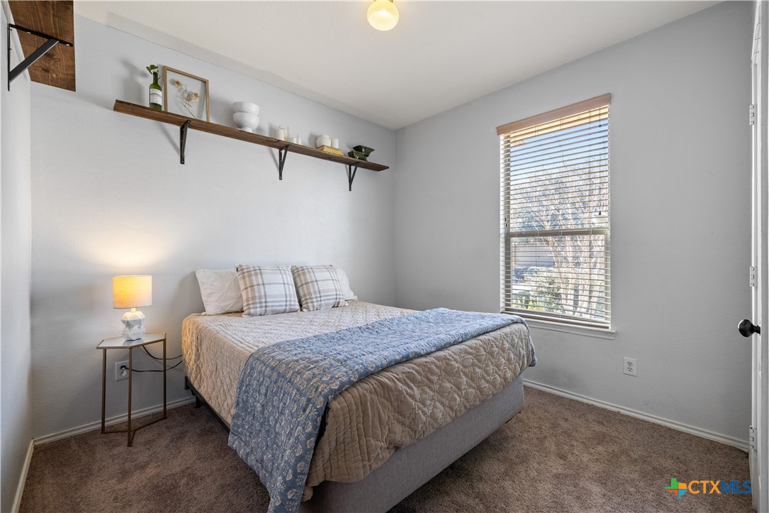 723 Tumbleweed Trail Temple, TX 76502 - Photo 21 of 38 a bedroom with a bed and two windows
