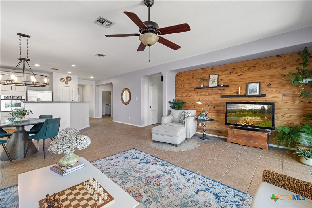 723 Tumbleweed Trail Temple, TX 76502 - Photo 6 of 38 a living room with furniture a flat screen tv and a fireplace