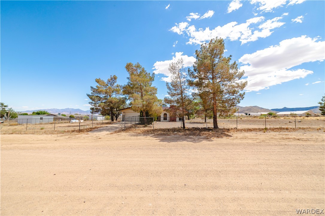 2100 East Valley View Road Kingman, AZ 86409 - Photo 2 of 53 Expansive desert landscape featuring a partially fenced lot with mature trees
