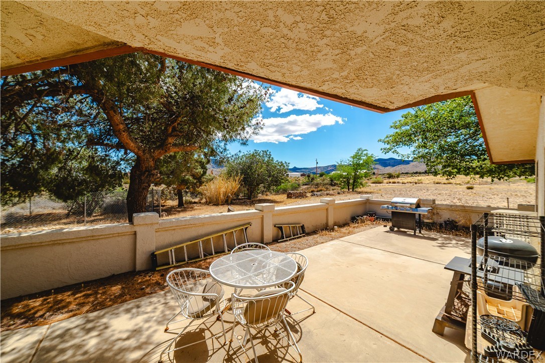 2100 East Valley View Road Kingman, AZ 86409 - Photo 36 of 53 Covered patio with textured ceiling, concrete flooring, and a low privacy wall