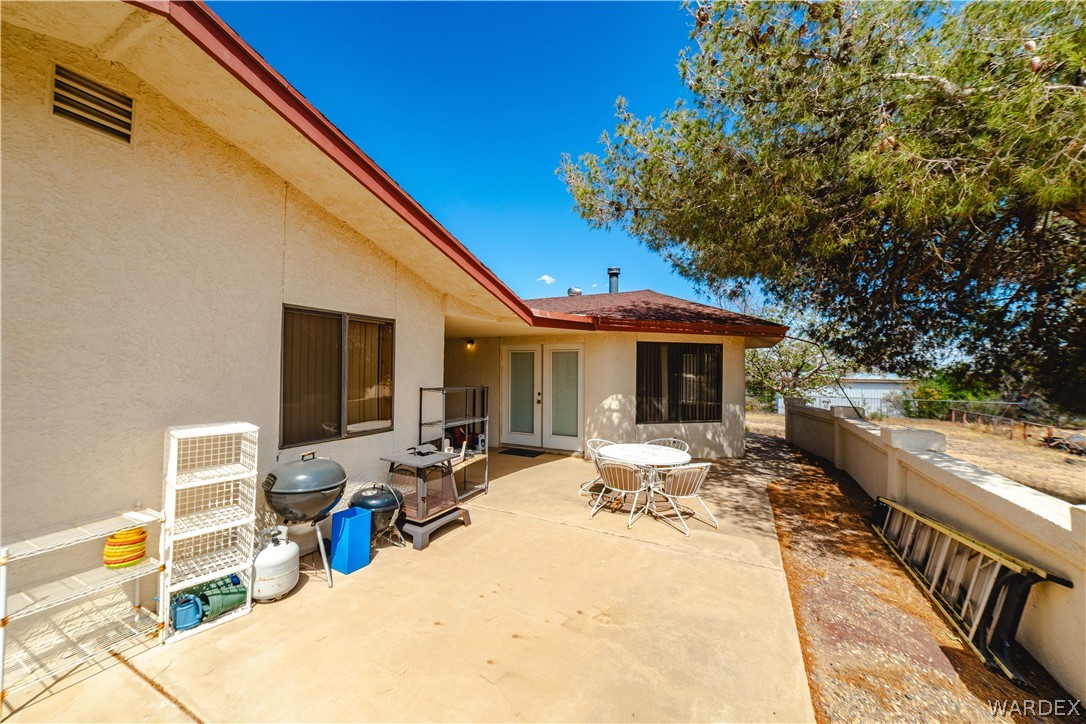2100 East Valley View Road Kingman, AZ 86409 - Photo 39 of 53 Exterior patio featuring a concrete surface, stucco siding, and a red tile roof