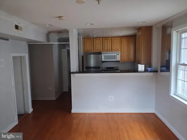 a kitchen with stainless steel appliances granite countertop a refrigerator a sink and a stove top oven