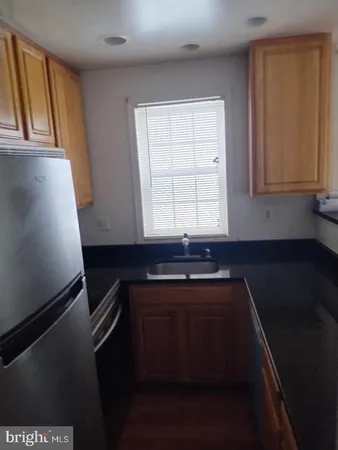 a kitchen with a sink a stove and cabinets