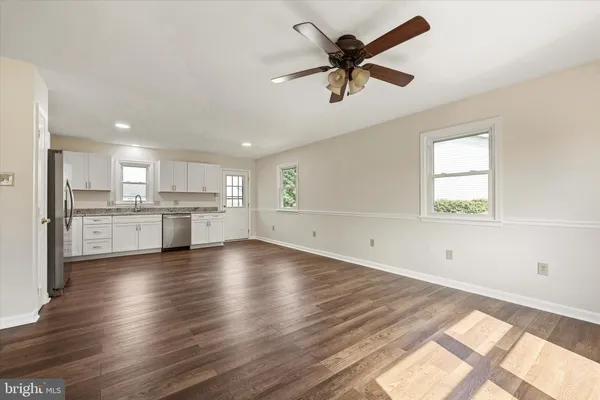 a view of a kitchen with a sink hardwood floor and a window