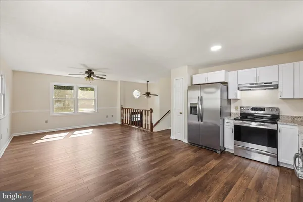 a kitchen with stainless steel appliances a refrigerator and a stove top oven