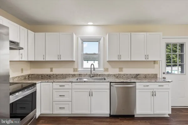 a kitchen with appliances cabinets and a sink
