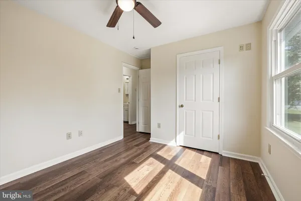 wooden floor in an empty room with a window