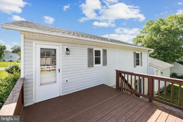 a view of a house with wooden deck