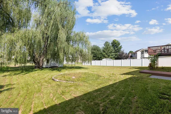 a swimming pool with outdoor seating and yard