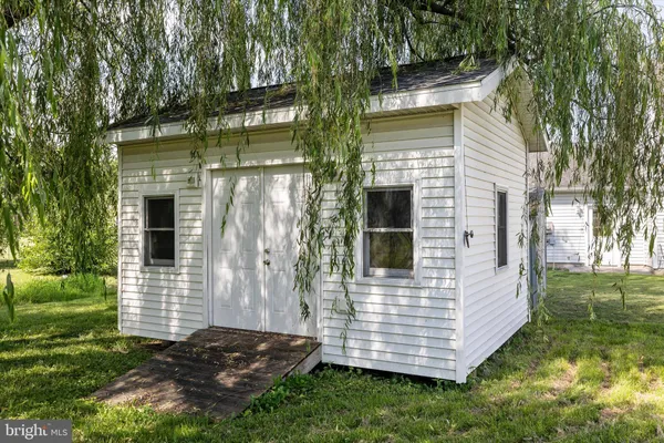 a view of a small house with backyard