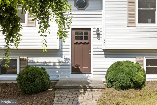 a view of a pathway of a house with plants