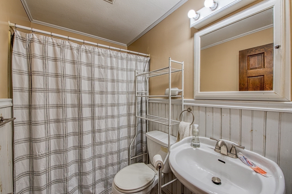 12 Brewster Road Randolph, MA 02368 - Photo 13 of 27 a bathroom with a sink and a toilet