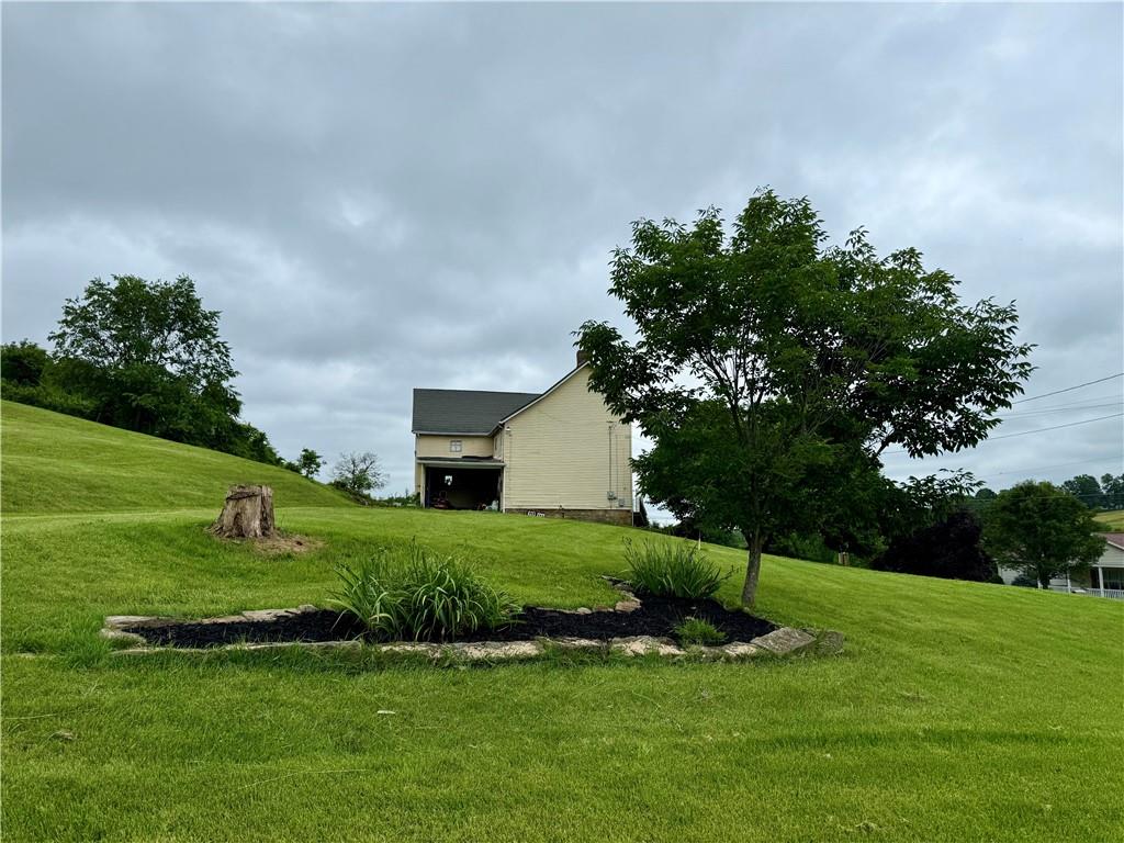 2072 Garards Fort Road Waynesburg, PA 15370 - Photo 6 of 33 a view of a house with a big yard potted plants and large tree