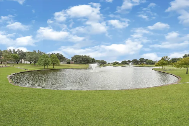 an aerial view of a house with a yard and lake view