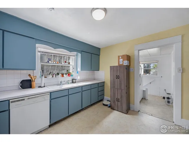 a kitchen with stainless steel appliances a sink cabinets and a window