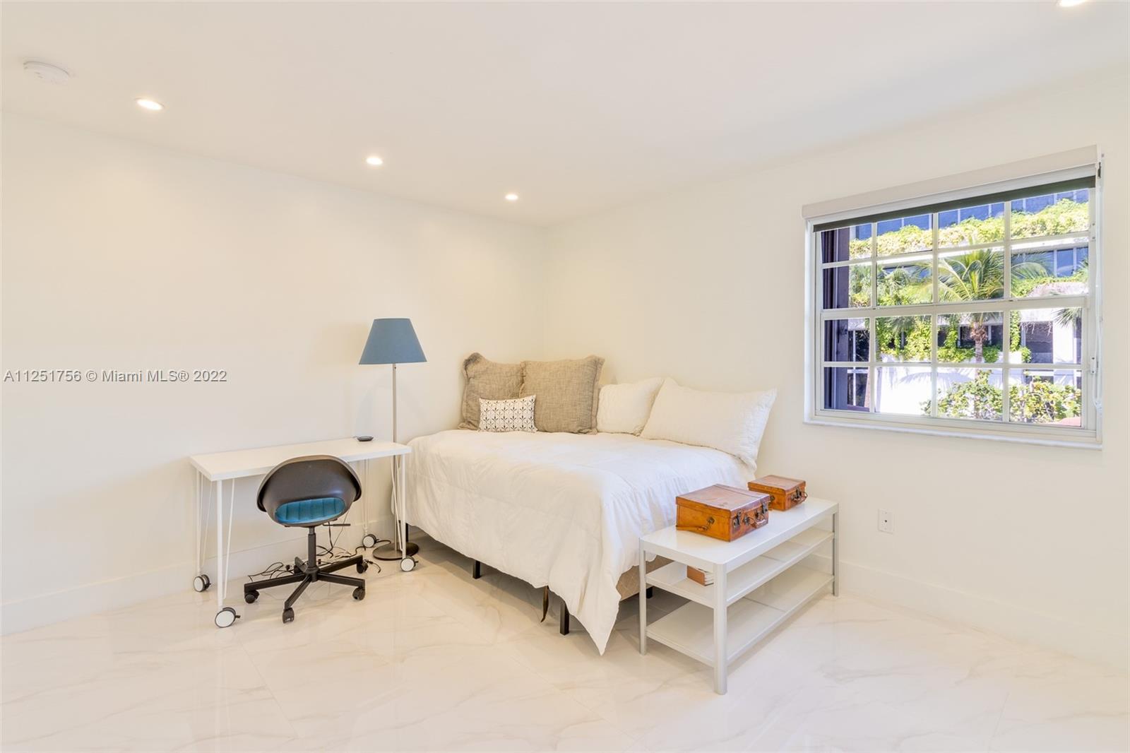 9076 Harding Avenue Surfside, FL 33154 - Photo 17 of 37 a bedroom with a bed and a desk