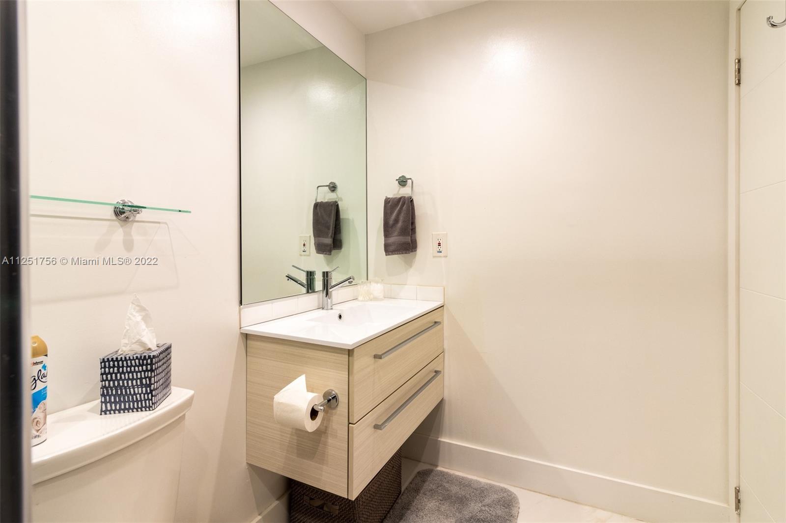 9076 Harding Avenue Surfside, FL 33154 - Photo 19 of 37 a bathroom with a sink a vanity and a mirror