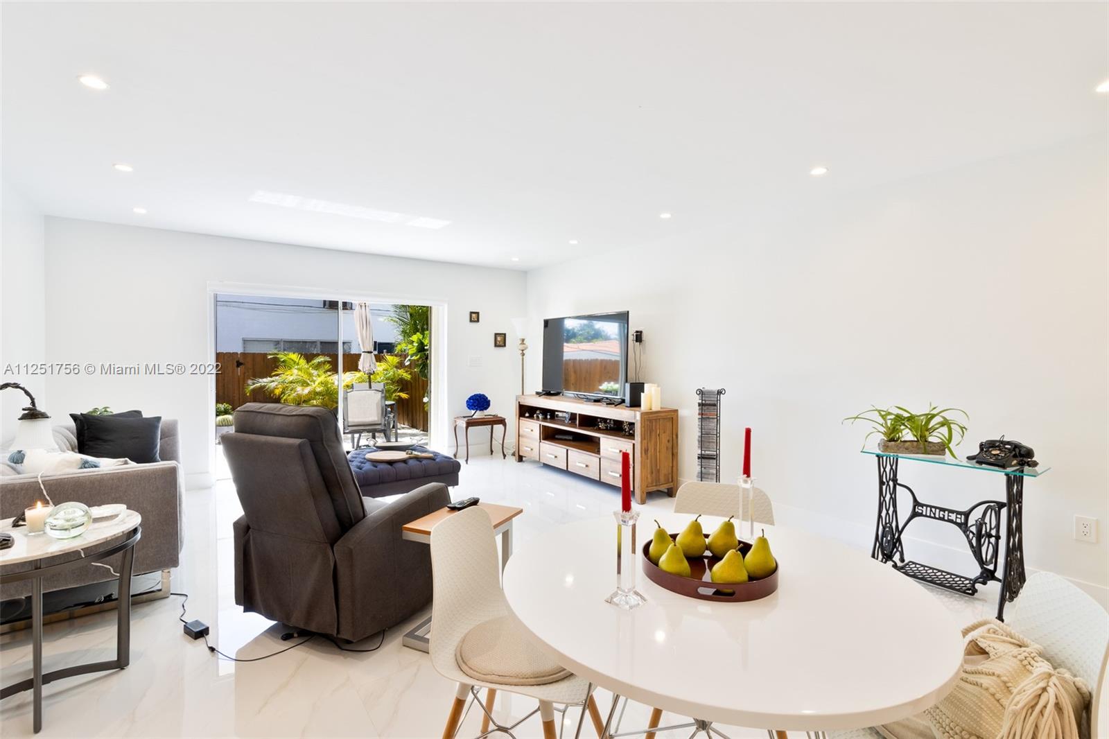 9076 Harding Avenue Surfside, FL 33154 - Photo 2 of 37 a living room with furniture and white wooden floor