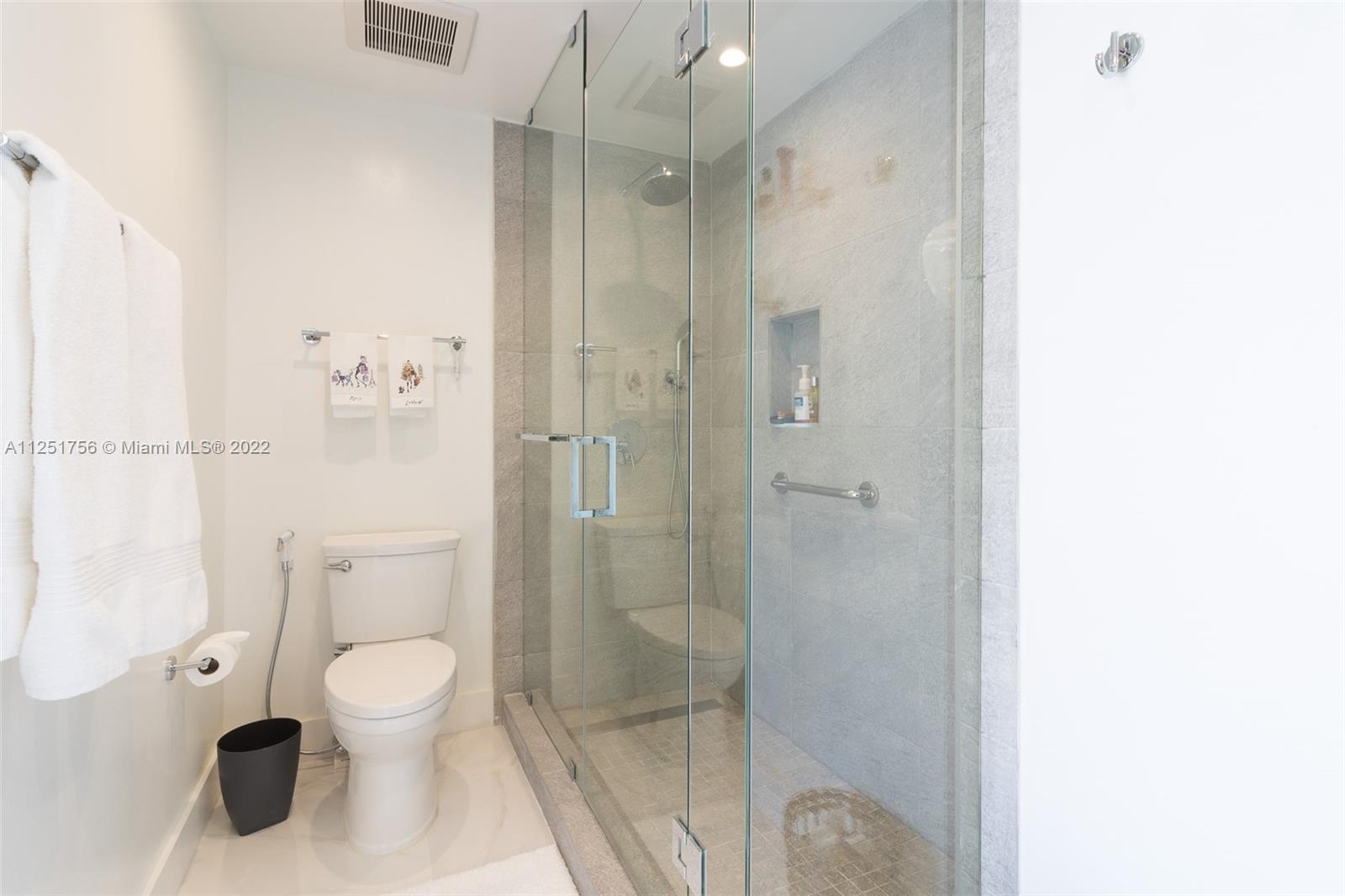 9076 Harding Avenue Surfside, FL 33154 - Photo 24 of 37 a bathroom with a toilet and a shower