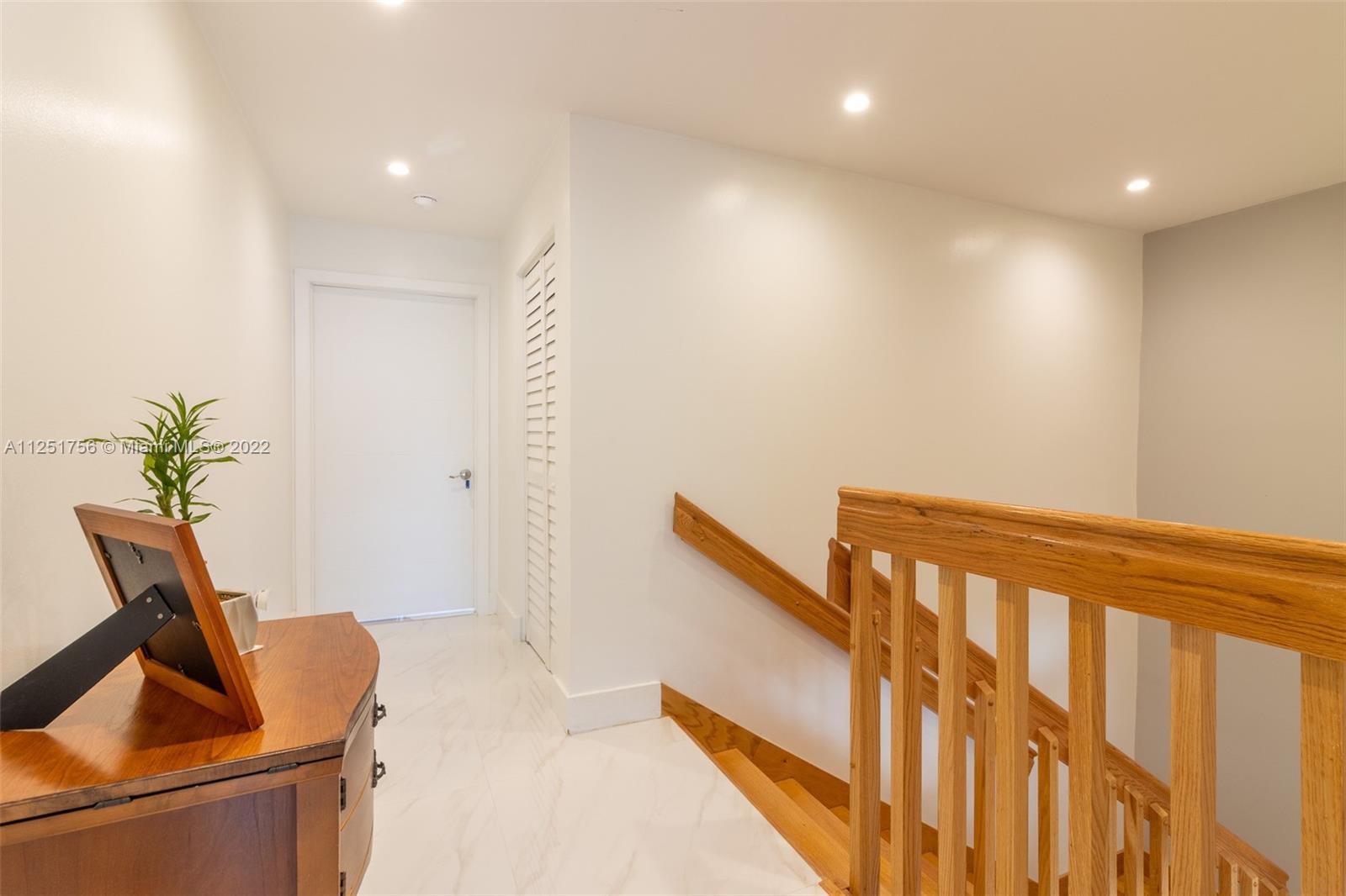 9076 Harding Avenue Surfside, FL 33154 - Photo 26 of 37 a view of staircase with white walls