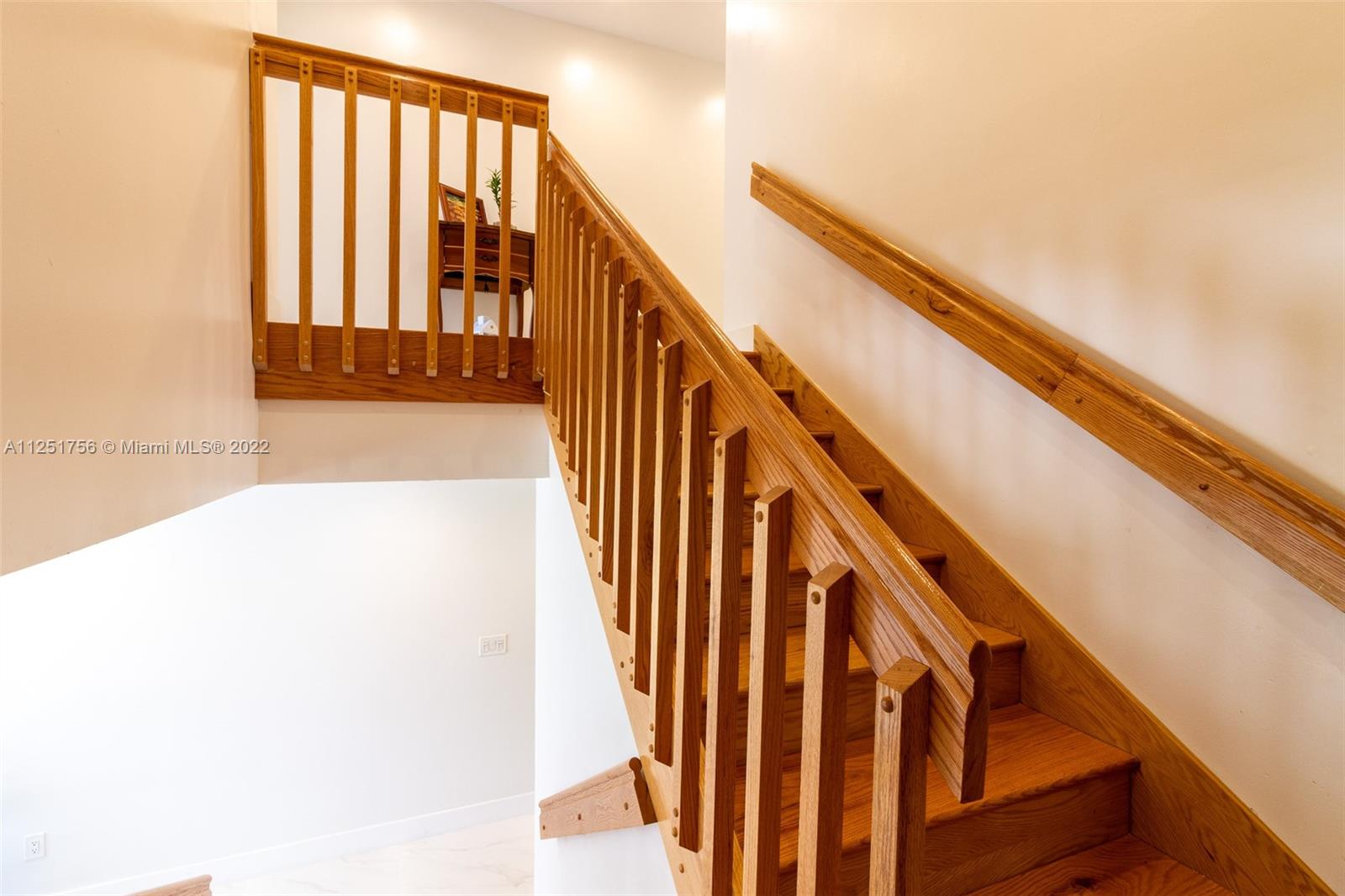 9076 Harding Avenue Surfside, FL 33154 - Photo 28 of 37 a view of staircase with railing and white walls