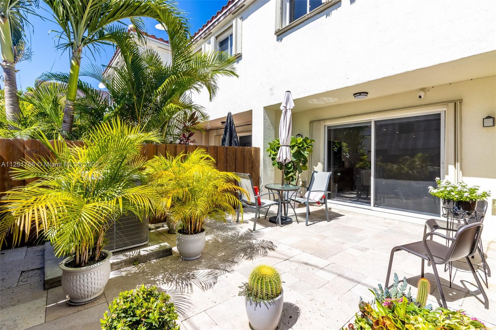 9076 Harding Avenue Surfside, FL 33154 - Photo 30 of 37 a view of a swimming pool with potted plants