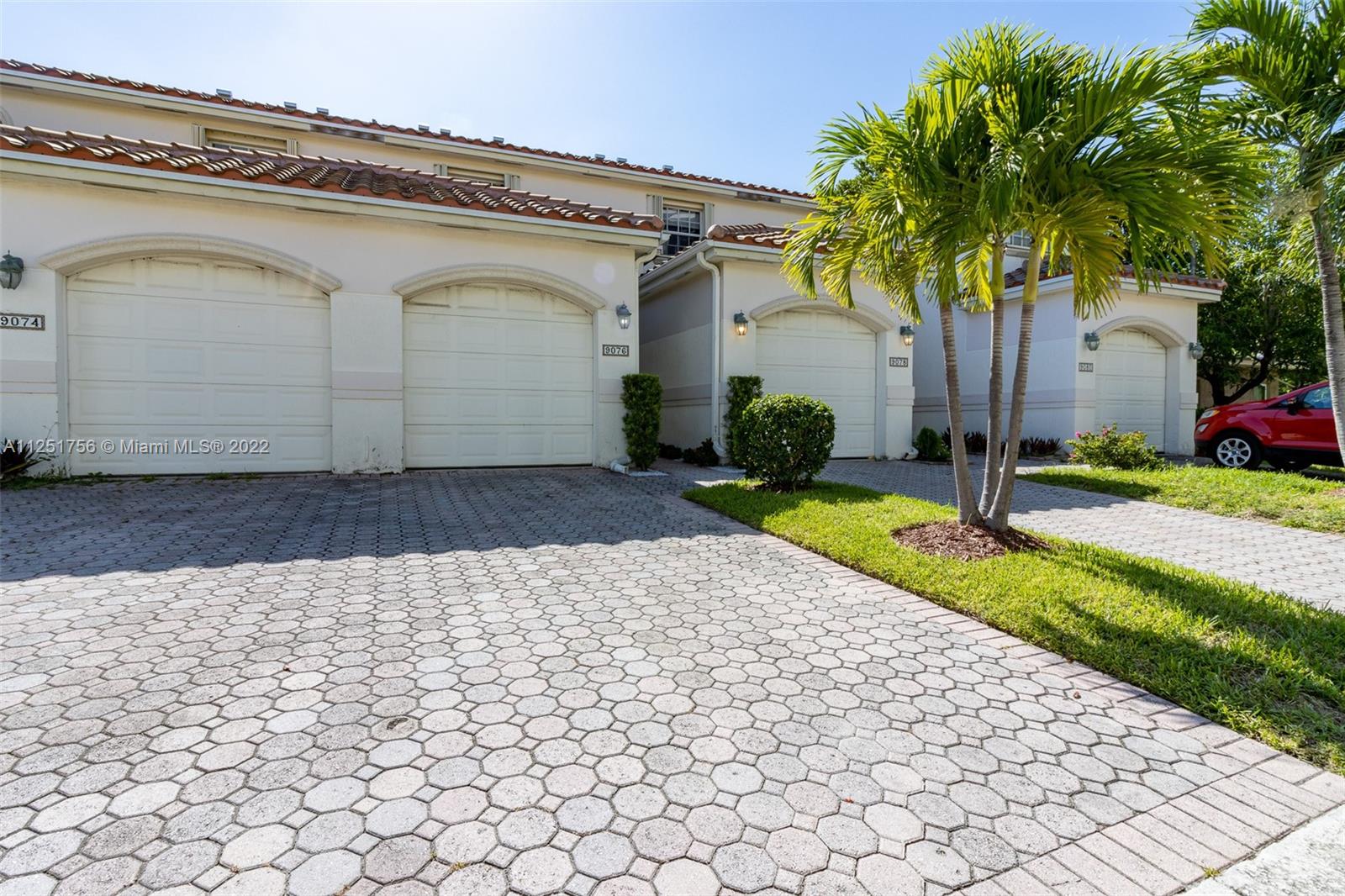 9076 Harding Avenue Surfside, FL 33154 - Photo 34 of 37 a front view of a house with garden