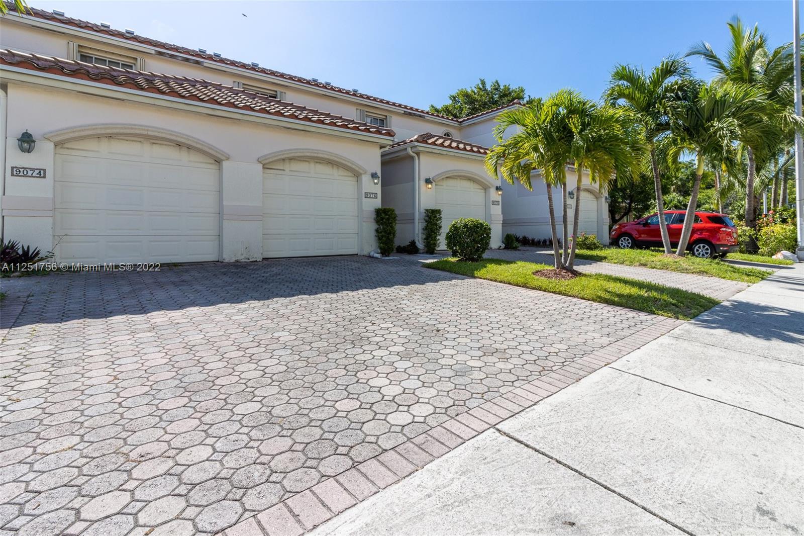 9076 Harding Avenue Surfside, FL 33154 - Photo 35 of 37 a front view of a house with garden