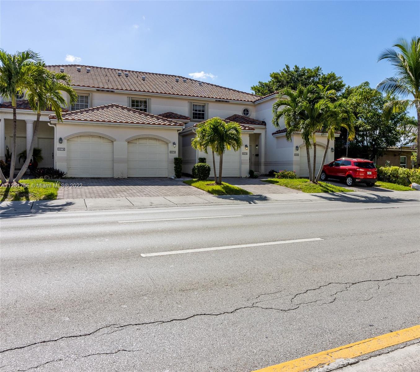 9076 Harding Avenue Surfside, FL 33154 - Photo 36 of 37 a view of parking and small yard