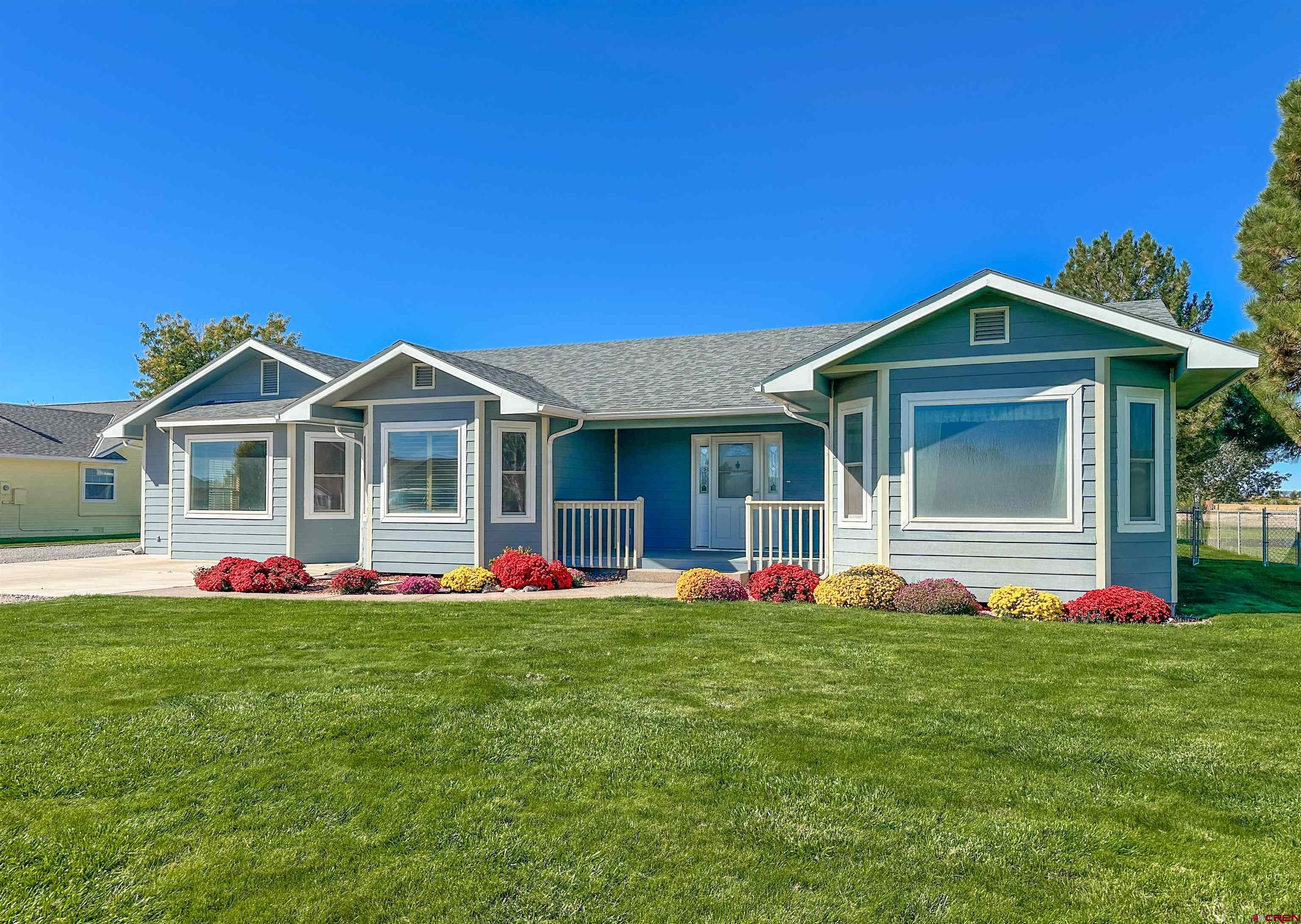 a front view of house with yard and green space