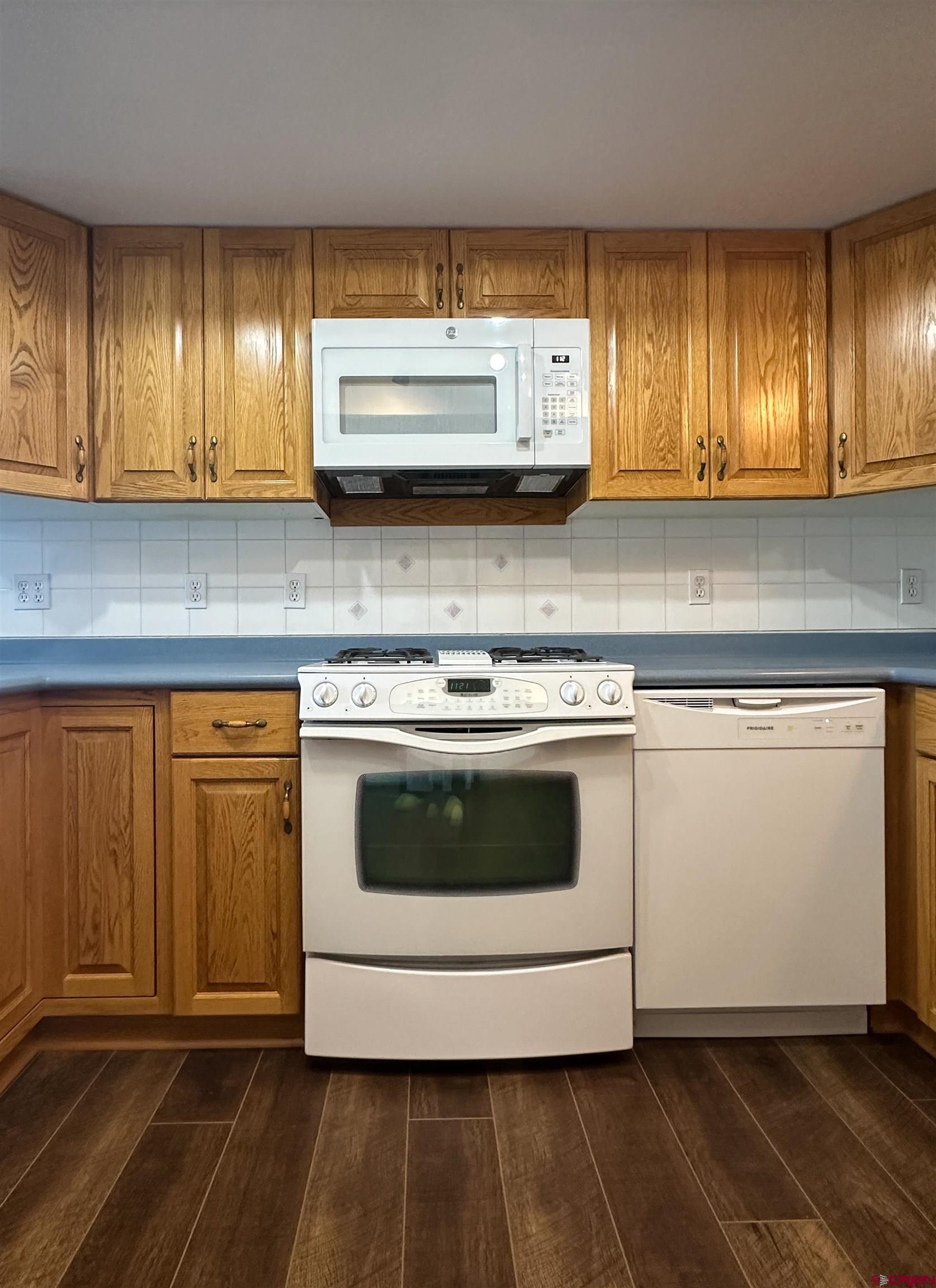 2461 1585 Road Delta, CO 81416 - Photo 8 of 45 a kitchen with granite countertop wooden cabinets and white appliances