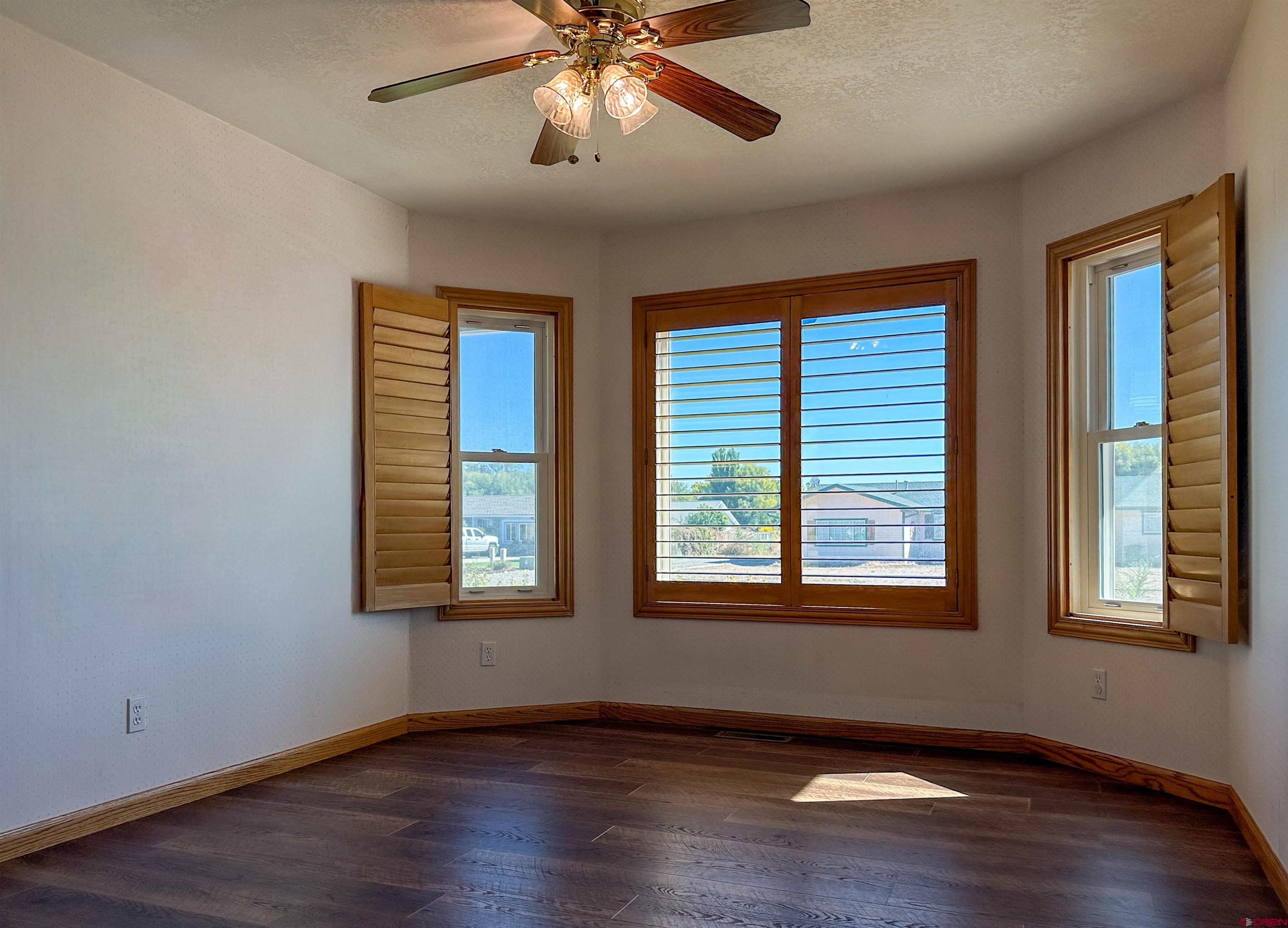 2461 1585 Road Delta, CO 81416 - Photo 9 of 45 a view of an empty room with wooden floor and a window