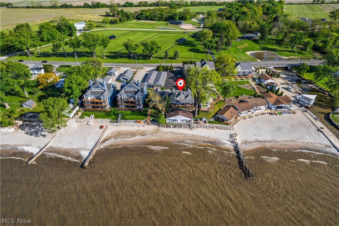 13011 West Lake Road Vermilion, OH 44089 - Photo 3 of 29 Waterfront property featuring a private beach, multiple residential structures, and a boat launch