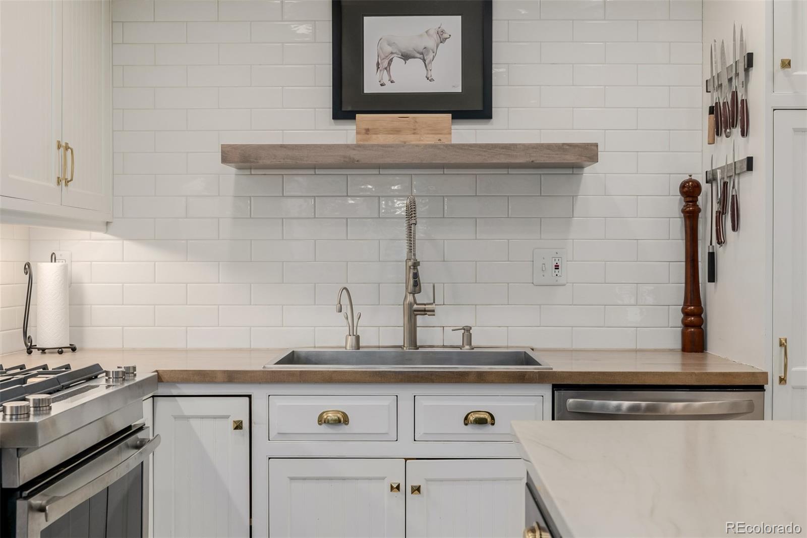 353 Bellaire Street Denver, CO 80220 - Photo 18 of 50 a white kitchen with granite countertop white cabinets and white appliances