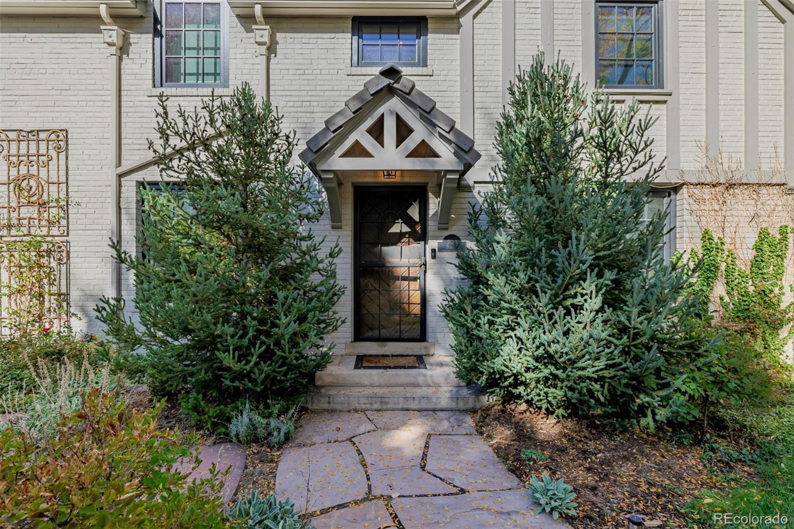 353 Bellaire Street Denver, CO 80220 - Photo 2 of 50 a front view of a house with garden