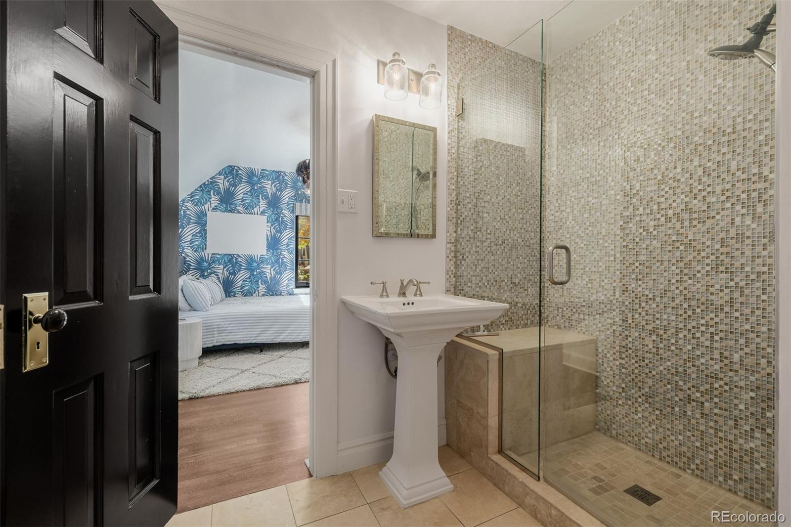 353 Bellaire Street Denver, CO 80220 - Photo 27 of 50 a bathroom with a sink a mirror and shower