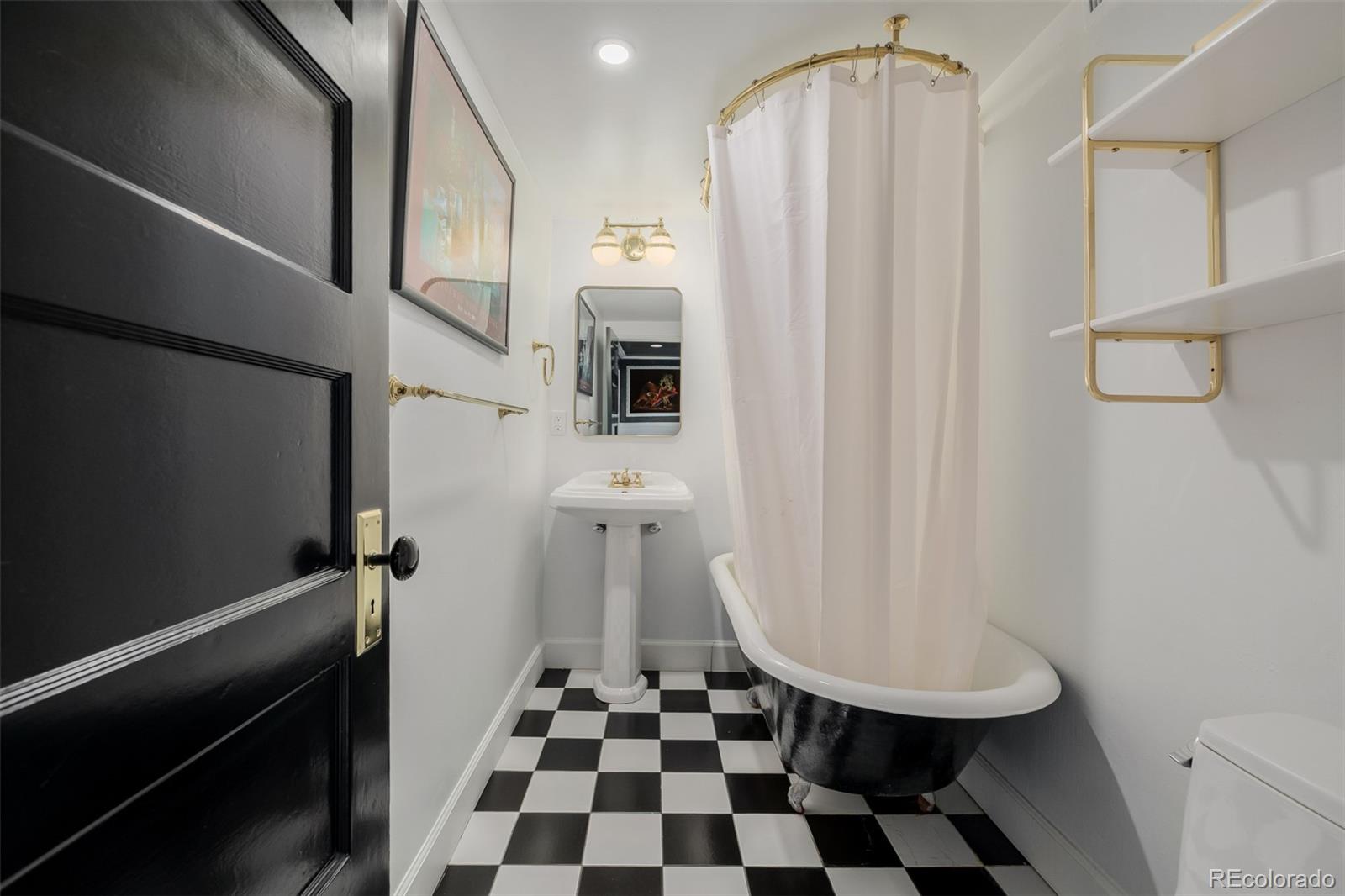 353 Bellaire Street Denver, CO 80220 - Photo 36 of 50 a bathroom with a sink a toilet a shower and a mirror