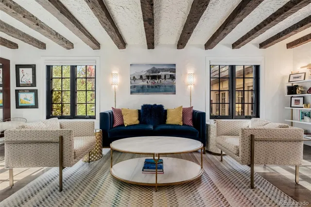 a living room with furniture kitchen fireplace and a fireplace