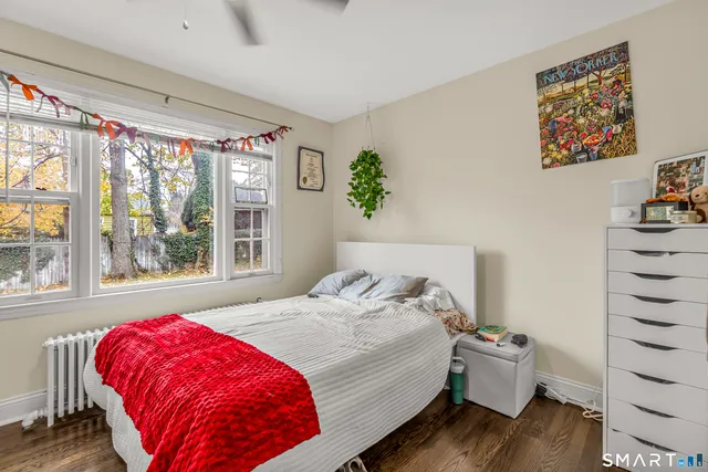 a bed sitting in a bedroom next to a window