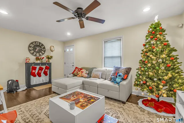 a living room with furniture and a chandelier