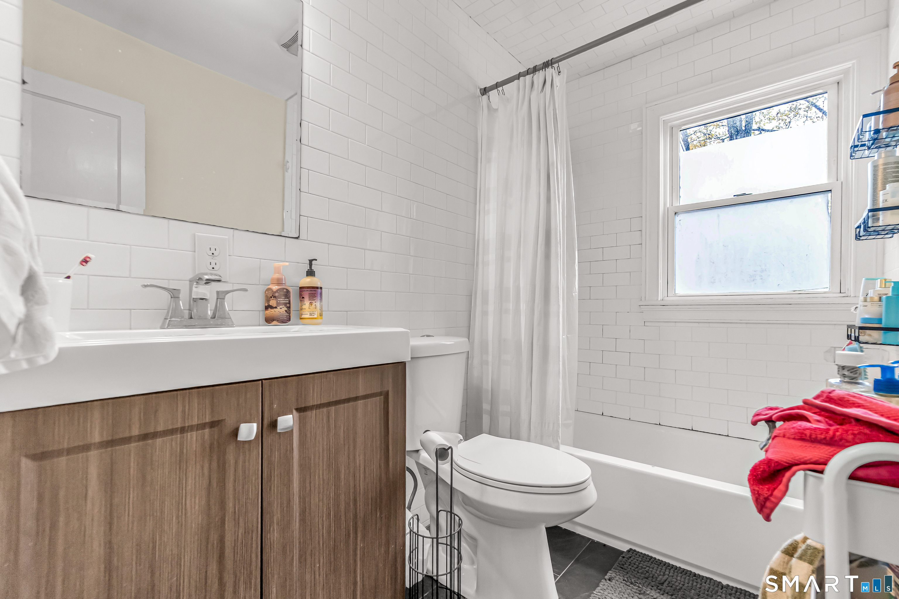 619 Queen Street Bridgeport, CT 06606 - Photo 8 of 16 a bathroom with a sink toilet and shower