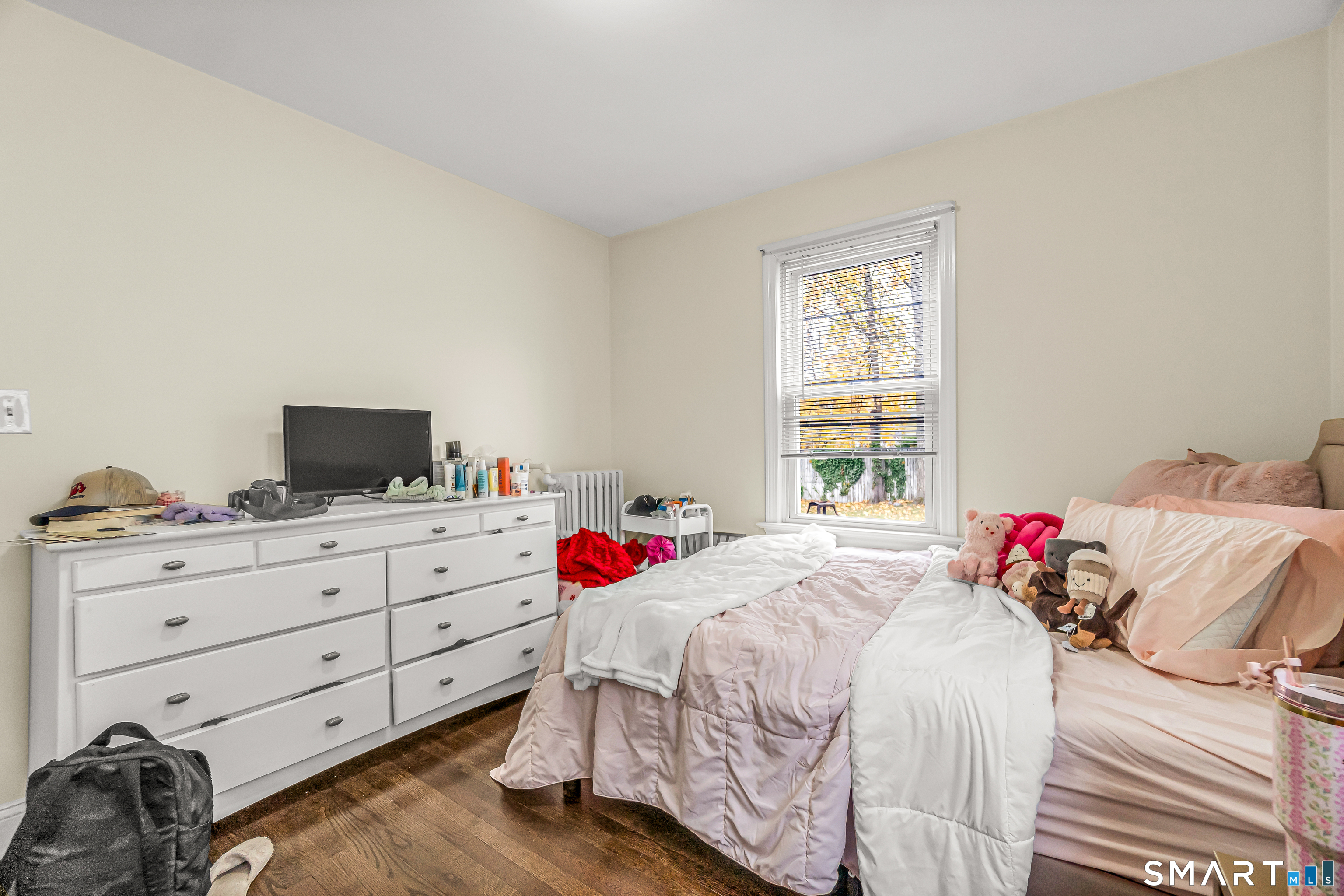 619 Queen Street Bridgeport, CT 06606 - Photo 9 of 16 a bed room with a bed and a television