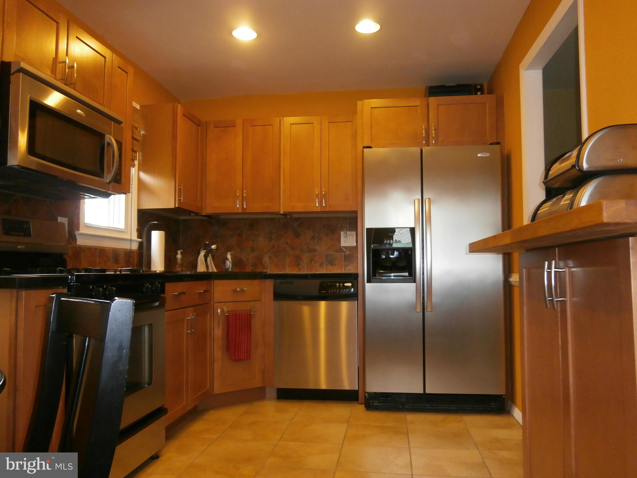 5636 Whitby Road Baltimore, MD 21206 - Photo 4 of 17 a kitchen with stainless steel appliances granite countertop a refrigerator a stove and a sink