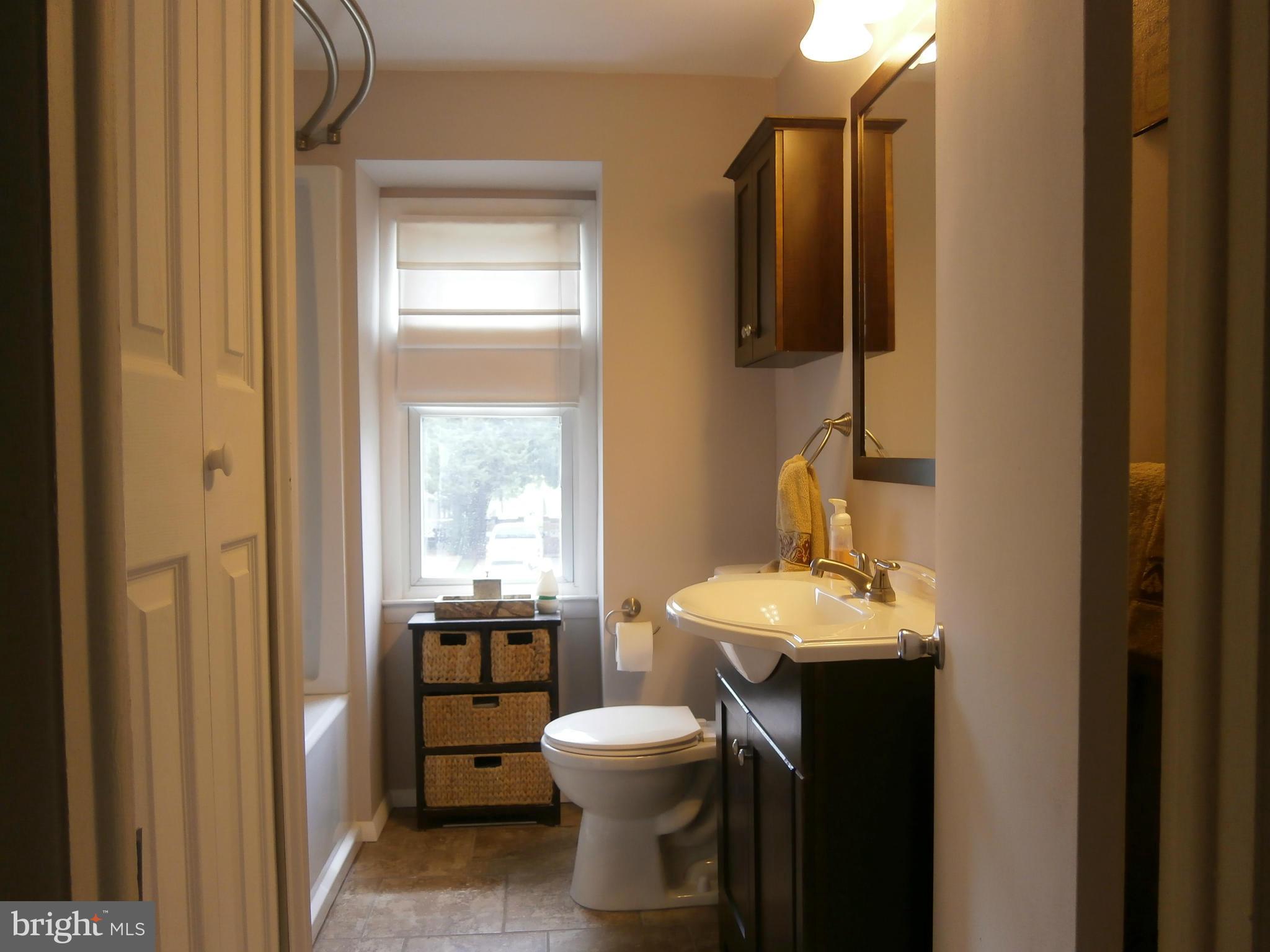 5636 Whitby Road Baltimore, MD 21206 - Photo 9 of 17 a bathroom with a sink toilet and mirror