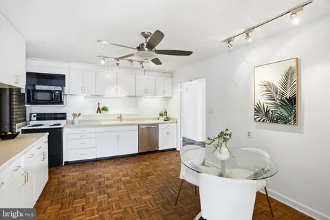 a kitchen with a stove a sink and a refrigerator