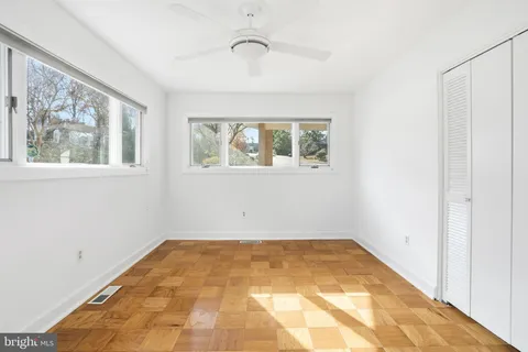 a spacious bedroom with a bed and a large window