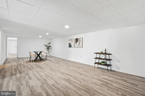 a view of empty room with wooden floor and workspace