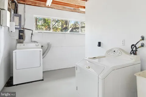 a bathroom with a granite countertop sink a toilet and a mirror