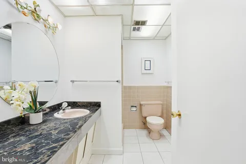 an empty room with wooden floor chandelier fan and windows