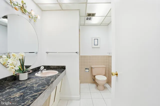 an empty room with wooden floor chandelier fan and windows